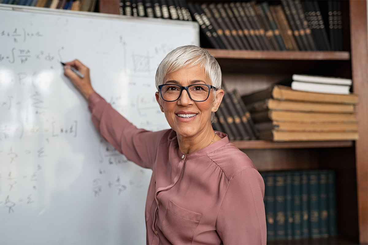 Lecturer Writing On Board With Eye Contact